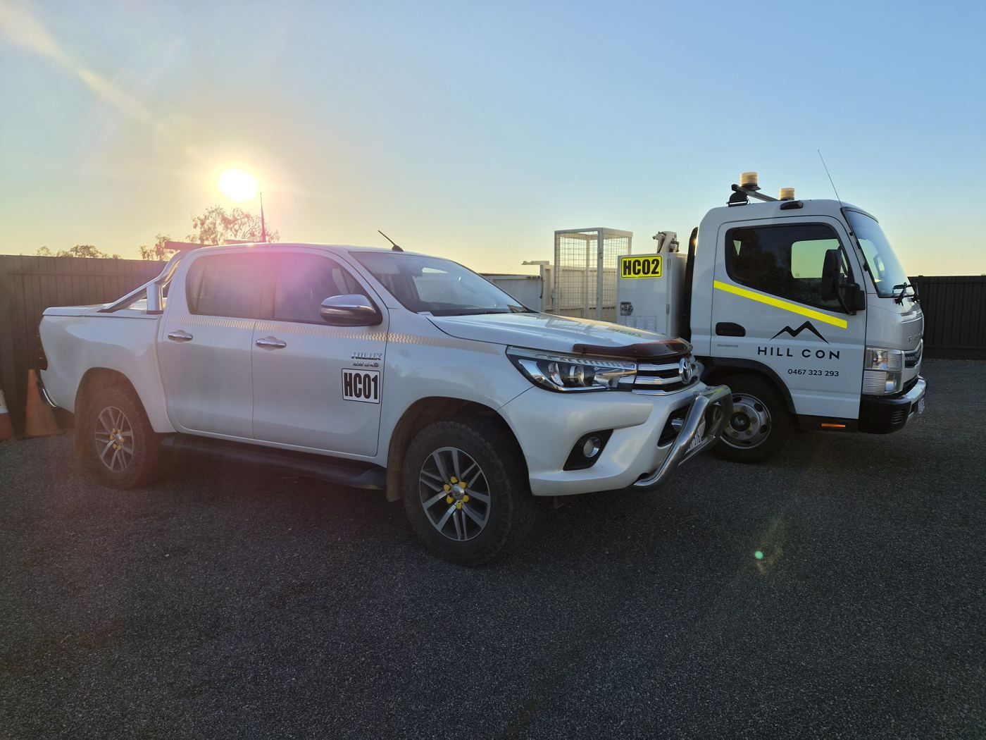 Hill Con fleet: Toyota Hilux HC01 and Fuso tipper HC02 at sunrise